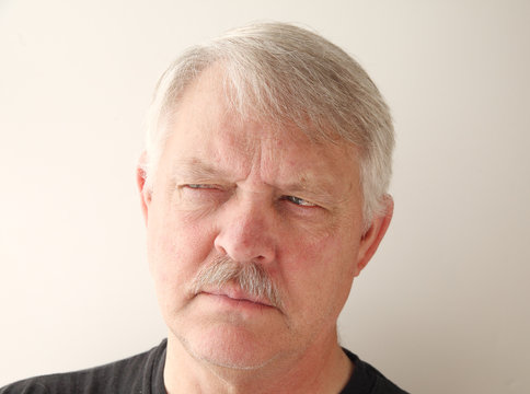 older man has a distrusting look
