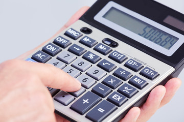 Hand with calculator.