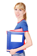 Female holding documents. The girl looks into the camera. Portrait of a cheerful student.