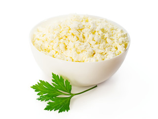 cottage cheese in a white bowl with a sprig of parsley