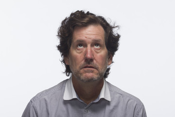 Man looks annoyed as he looks up, horizontal