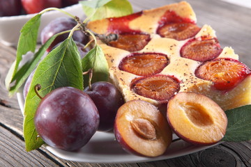 Plum cake over natural wood background 