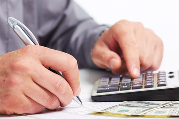Fototapeta premium Hands of businessman with calculator.