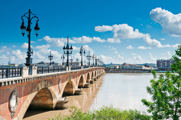 Old stony bridge in Bordeaux, France - obrazy, fototapety, plakaty