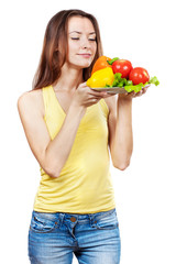 woman holding plate of fresh vegetables