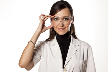 Smiling woman lab technician holds her goggles