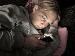 Woman on smartphone at night concept of cheating or affair
