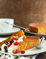Slices of carrot cake with whipped cream and berry