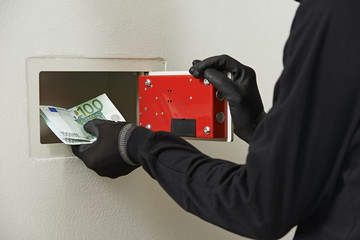 thief burglar at house safe breaking
