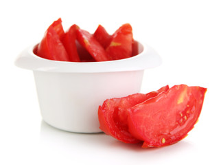 Bright fresh tomato cut up slices in bowl isolated on white
