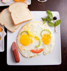 breakfast with fried eggs, toasts and juice