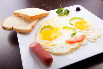 breakfast with fried eggs, toasts and Sausage