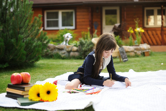 Cute Schoolgirl In Navy Uniform Drawing A Picture