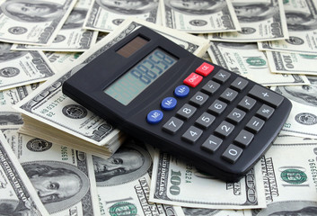 calculator on pile of dollars