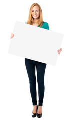 Attractive woman holding a blank sign