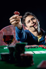 Poker player holding poker chip