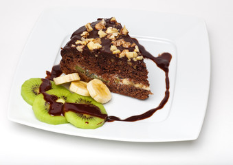 piece of chocolate cake with walnuts on the plate