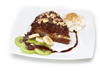 piece of chocolate cake with walnuts on the plate