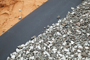 Geotextile layer between gravel and sandy ground