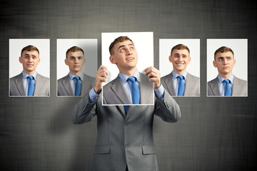 young man holds up a photograph