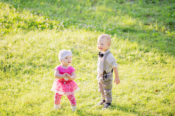 Fototapeta premium Children in beautiful spring green field