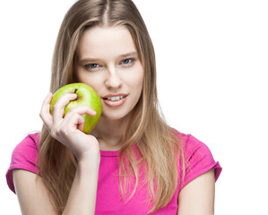 young beautiful blond woman holding green apple