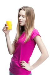 young beautiful blond woman drinking orange juice