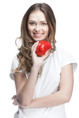 young beautiful brunette woman holding red pepper