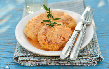 Minced meat and cabbage patties baked with tomato sauce