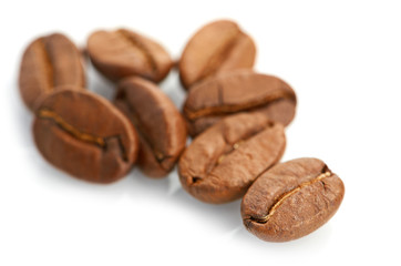 Macro of coffee beans isolated on white background