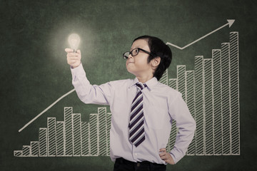 Confident business kid with increase bar chart