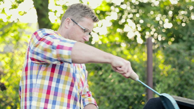 Father with son preparing grill in the garden
