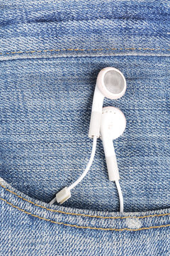 white earphone hanging out from jeans pocket