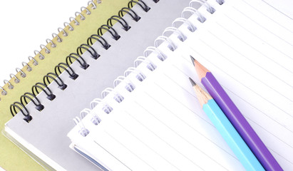Pencisl on stack of notebooks