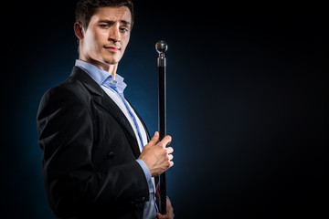 Elegant man holding cane with silver ball handle