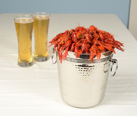 pail full of river lobster served with beer