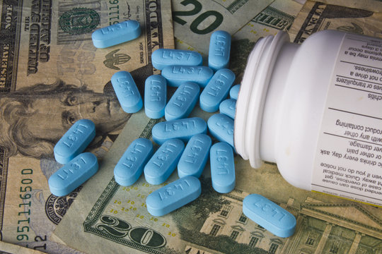 Blue Pills and Money Represent High Cost of Medicine