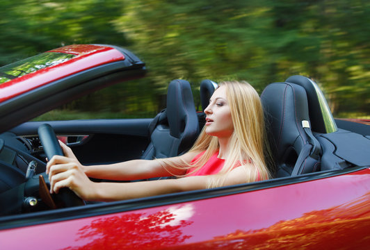 Young Woman Driving A Sports Car