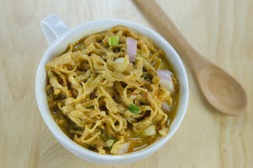 yellow noodles on wooden background