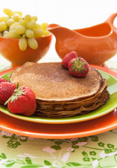 Stack of freshly  traditional pancakes (blini) with strawberries
