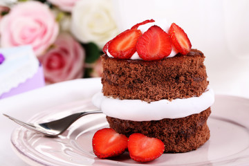 Chocolate cake with strawberry on table close-up