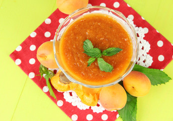 Apricot jam in glass bowl and fresh apricots,
