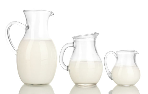 Milk in jugs isolated on white