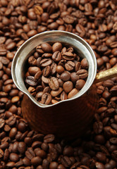 Metal turk on coffee beans background