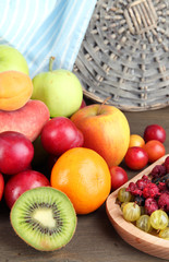 Assortment of juicy fruits, on wooden background
