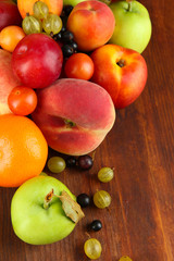 Assortment of juicy fruits, on wooden background