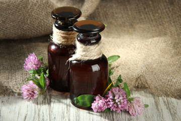 Fototapeta na wymiar Medicine bottles with clover flowers