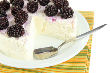 Cheesecake with fresh berries on white plate closeup