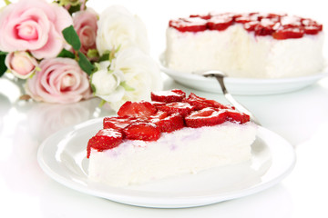 Cheesecake with fresh strawberry on white plate closeup