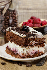 Chocolate and cherry cake. Coffee beans around, wooden backgroun